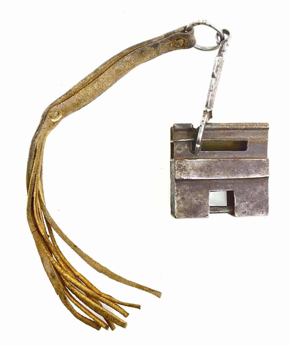 Antique-looking metal door lock plate with a ring key and large looped handle, shown isolated against a white background.
