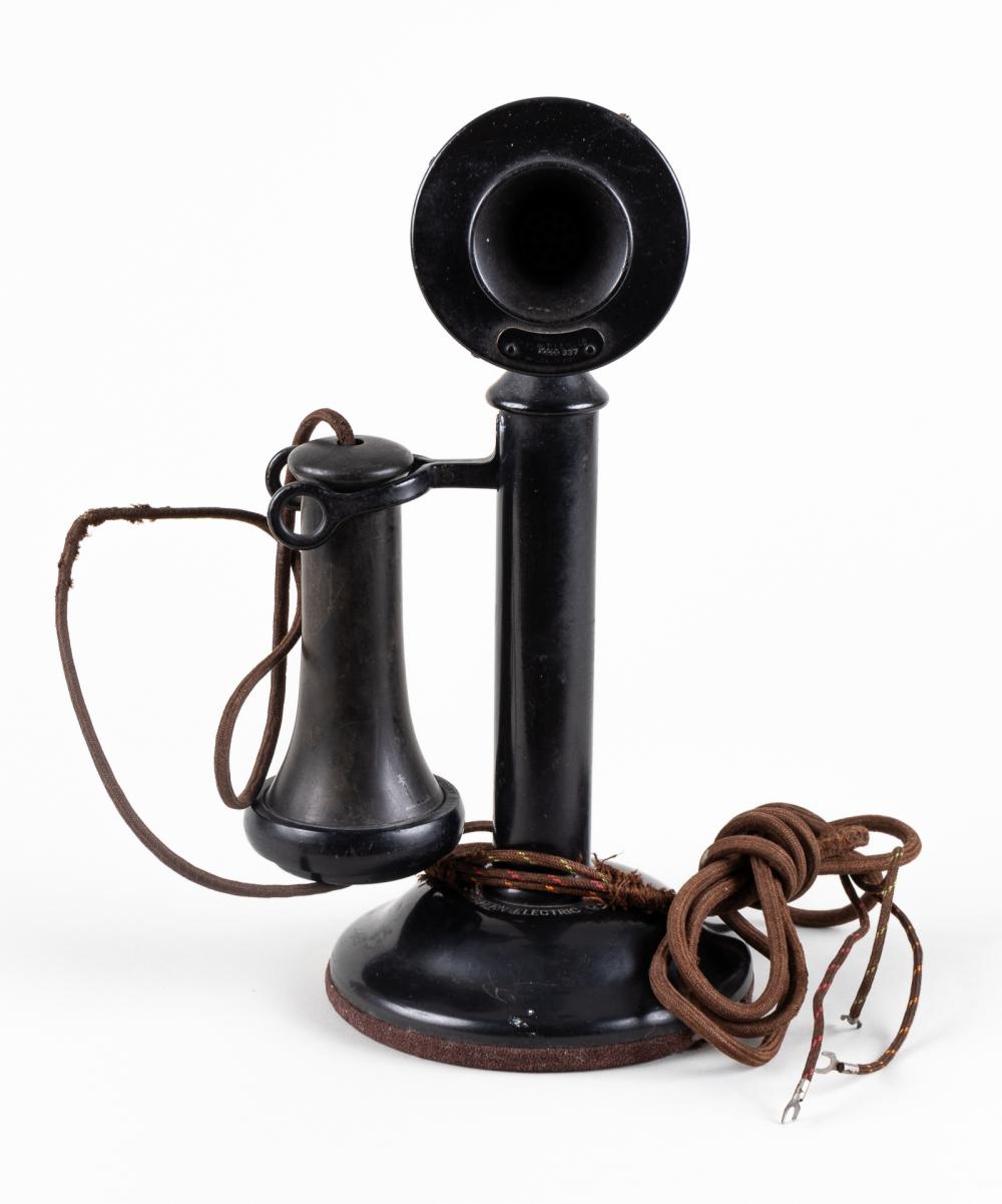 Black candlestick telephone handset and base with coiled brown cord and wiring, photographed on a white background.