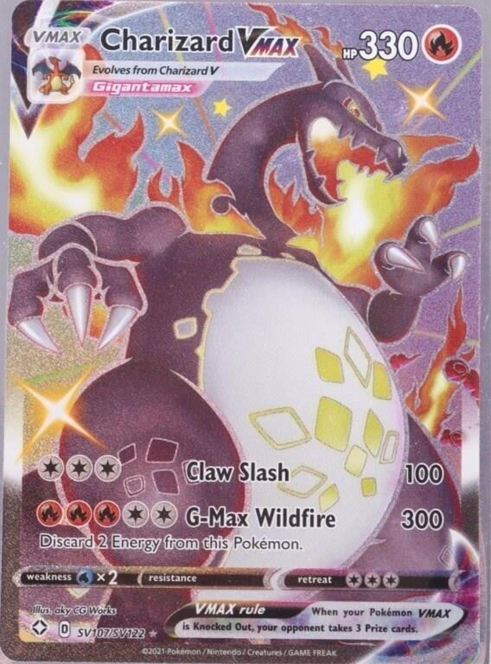Pokémon trading card showing Charizard VMAX with fiery artwork, HP 330, and move names “Claw Slash” and “G-Max Wildfire.”
