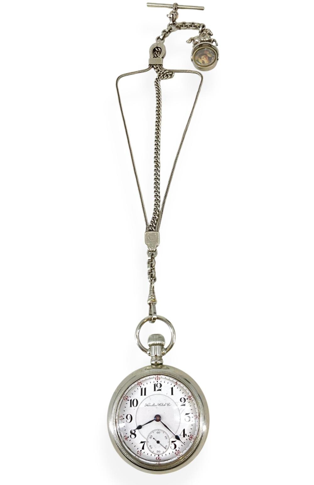 Silver-tone pocket watch with a chain and small fob attachments, shown against a white background.