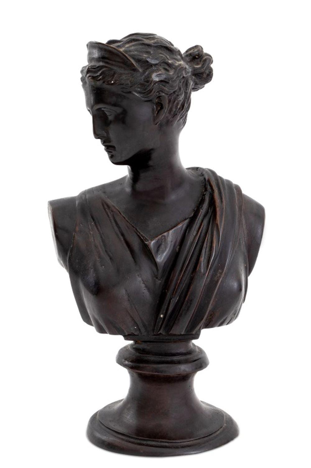 Bronze bust sculpture of a young woman in profile, with wavy hair and a draped garment, on a round base against a white background.