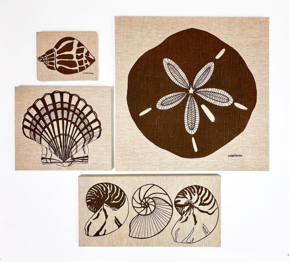 Four textile pictures depicting shells and a sand dollar, in an auction photograph.