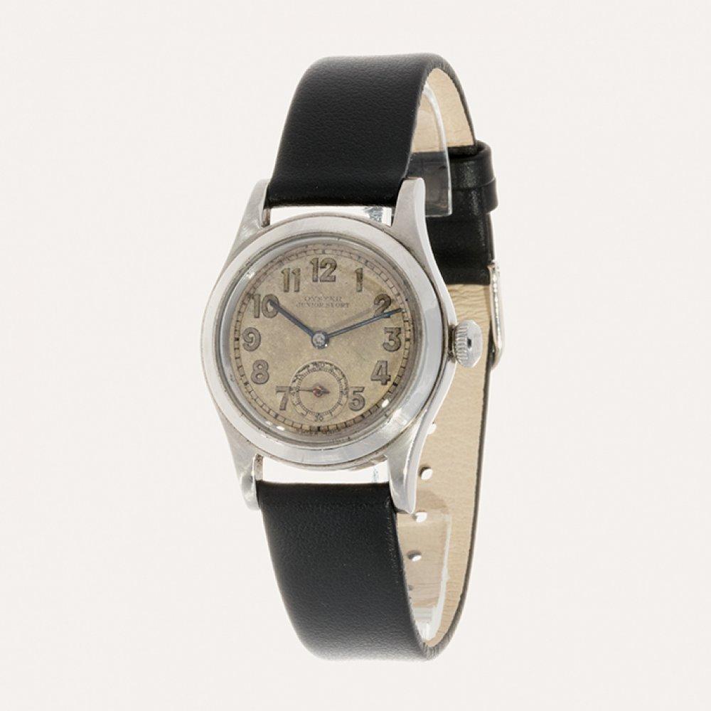 ROLEX Junior Sport vintage watch, ref. 3136, n. 1100XX. Steel. Stainless steel case with polished finish. Circular brown dial with applied Arabic numerals and blued steel baton hands. Second hand on subdial located at 6 o'clock. sold by Setdart Auction House, lot 24 — auction record photograph