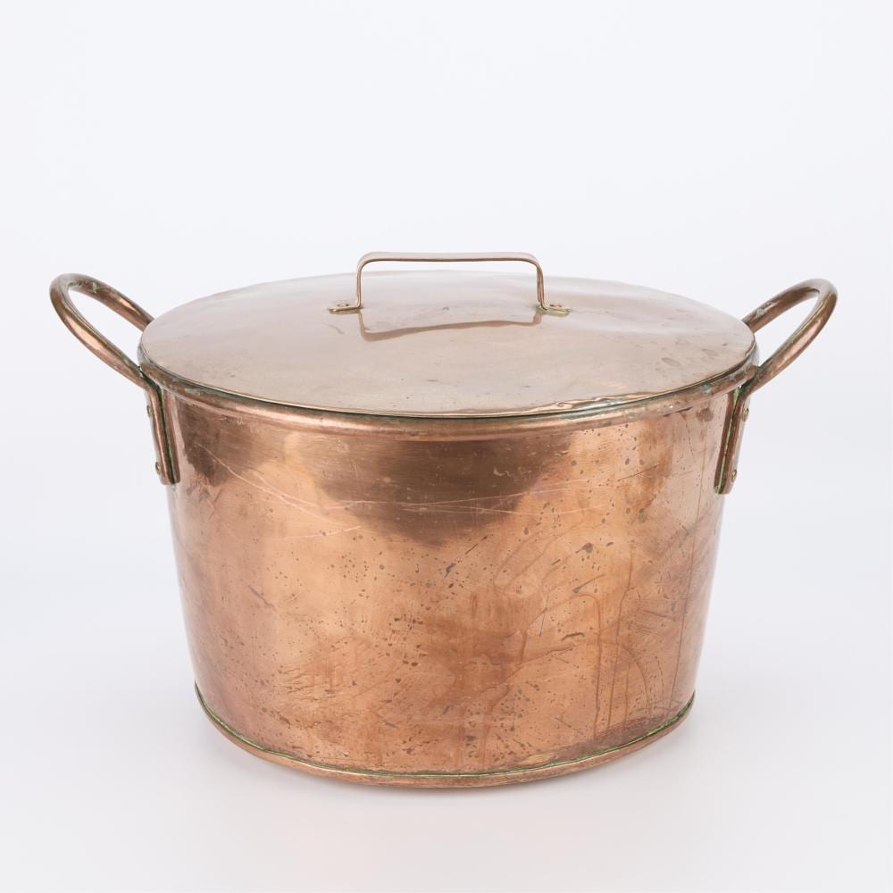 Large copper pot with lid and side handles, shown against a white background.