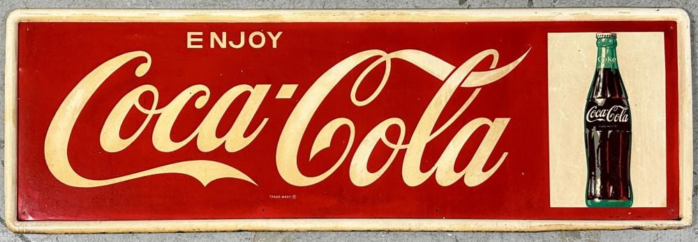 Rectangular Coca-Cola tin sign with red background reading “ENJOY Coca-Cola” and a bottle graphic on the right.