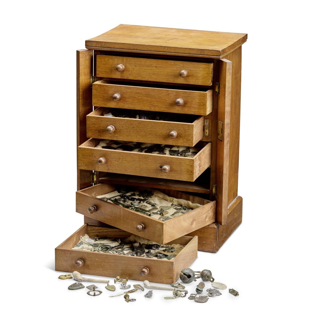 An antiquarian collector's cabinet, filled with an extensive collection of historical objects, including lead alloy pilgrim badges and Medieval horse harness pendants The cabinet second half 19th century, the contents Medieval and later (qty) sold by Bonhams, lot 2 — auction record photograph