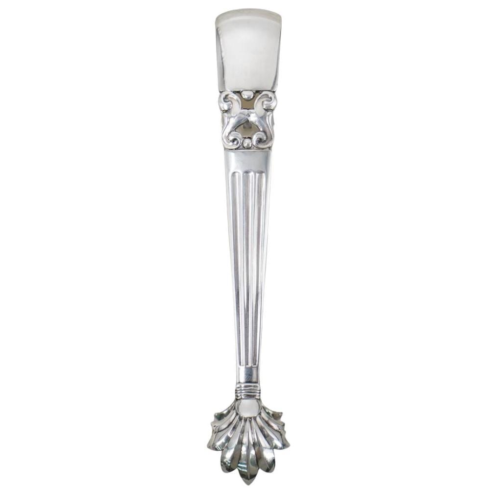 Sterling silver ice tong with ornate decorative collar and fluted grip, shown against a white background.