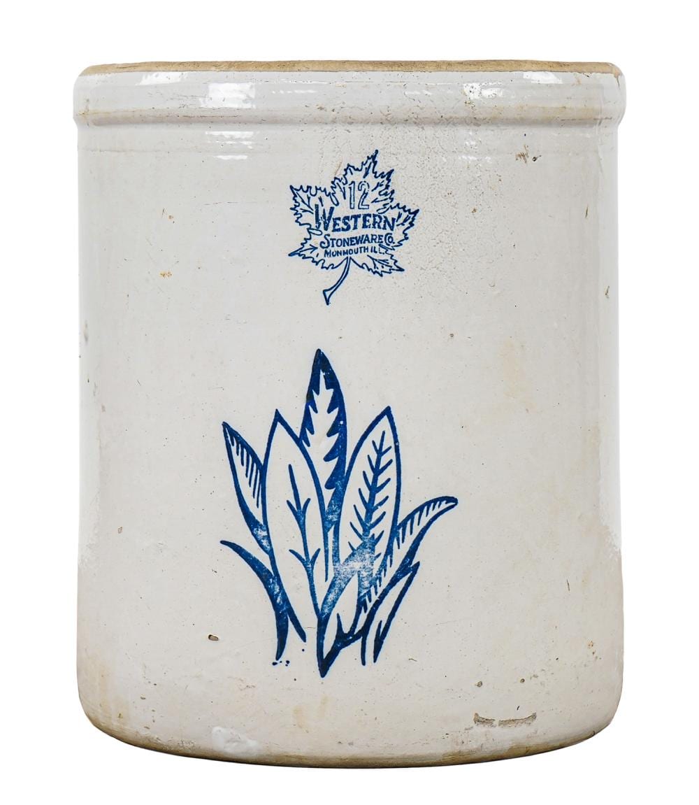 A large pale pottery crock with blue leaf decoration and Western Stoneware lettering, in an auction photograph.