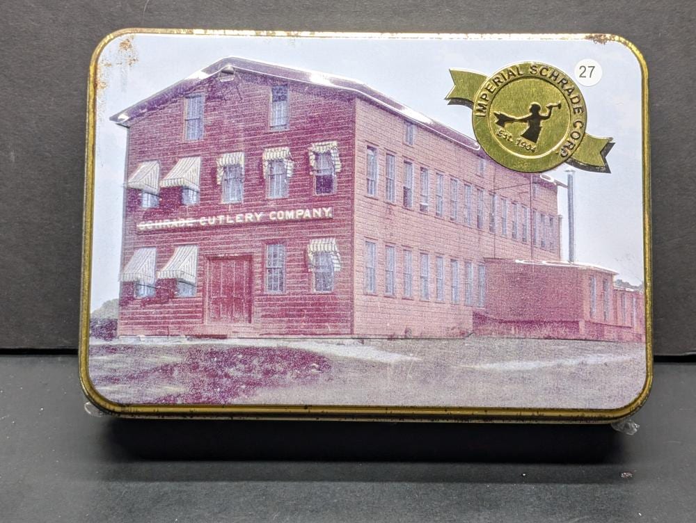 Schrade Building (Tin rusted) w/ Old Timer 94OTW Gunstock Trapper 6.9in SS Pocket Knife in new condition -NIP Unopened sold by Richard L. Edwards Auctioneer, lot 27 — auction record photograph
