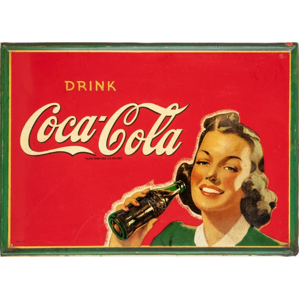 Red Coca-Cola advertisement sign reading “Drink Coca-Cola” with a smiling woman holding a bottle, shown in a green frame.