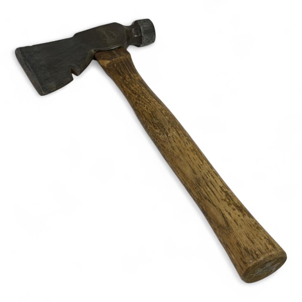 Vintage carpenter's hatchet with a dark metal head and wooden handle shown diagonally against a white background.