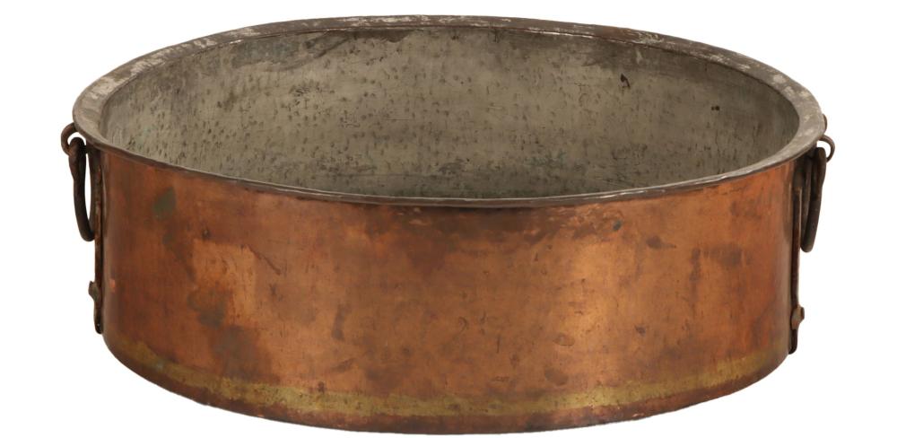 Large copper pot with iron handles, shown front view against a white background.