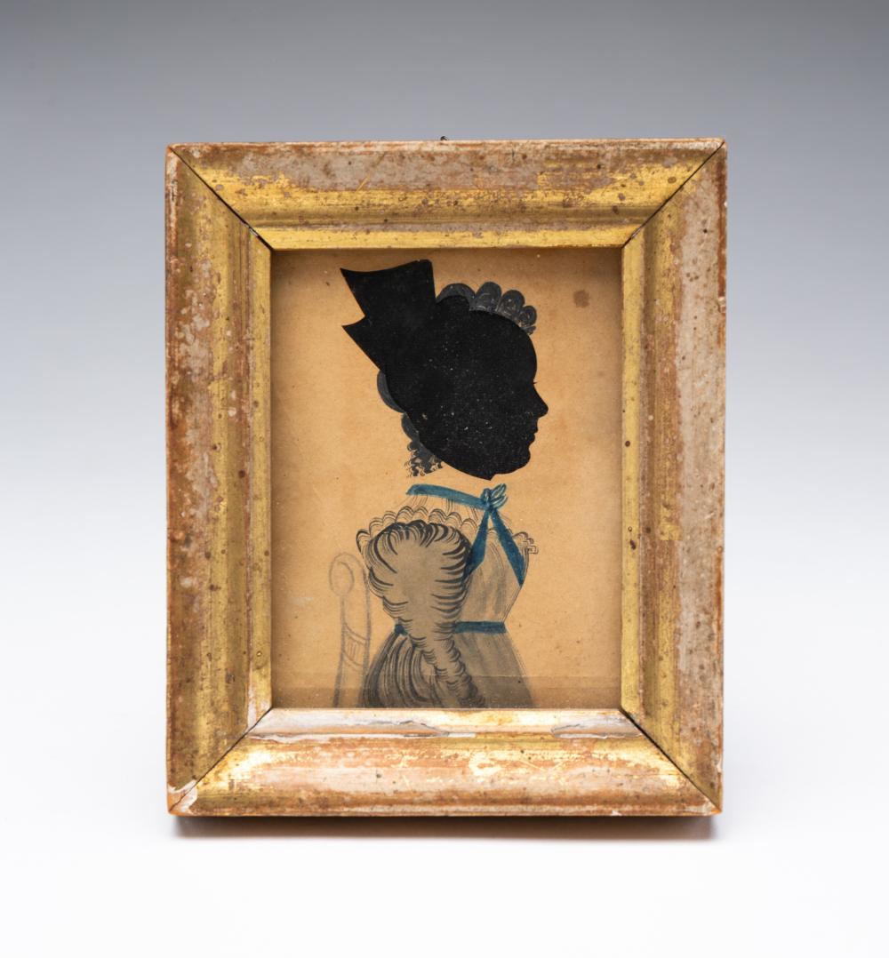 Framed silhouette portrait of a woman in profile with a dark head and hair shape, over a blue and cream painted background.