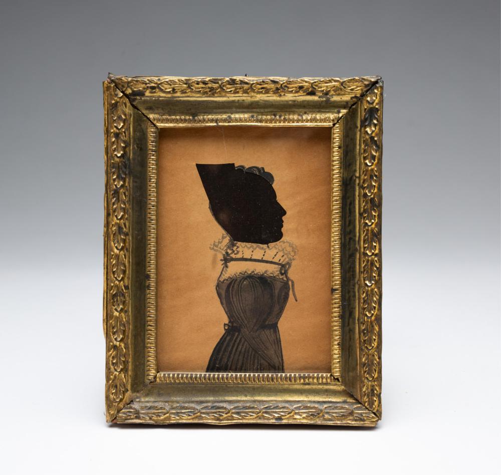 Portrait silhouette of a woman in a gold ornate frame, with black cutout head and clothing details on a light background.