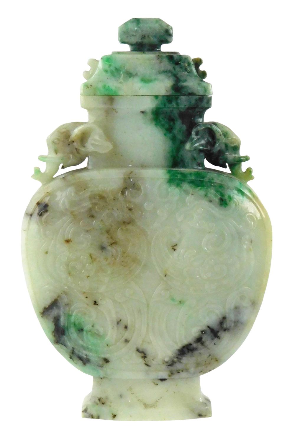 ASIAN: Flat covered hardstone vase with flanking elephant head handles, Chinese, 20th C., variegated stone possibly jadeite, stepped dome top over tapered neck and bulbous body, center decoration on both sides feature... sold by Winter Associates, Inc., lot 264 — auction record photograph