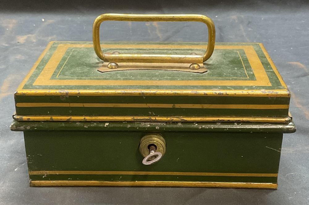 Vintage green and gold metal cash lock box with brass handle on top and circular key lock on the front.