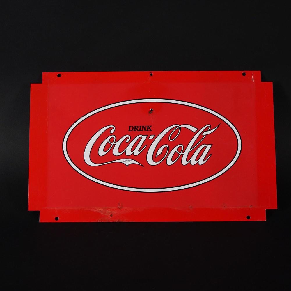 Red advertising tin sign featuring a large oval “Drink Coca-Cola” logo on a black background.