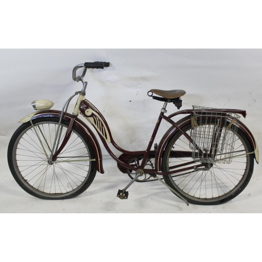 Red vintage bicycle with front wire basket, curved fenders, and a rear seat on a white studio background.