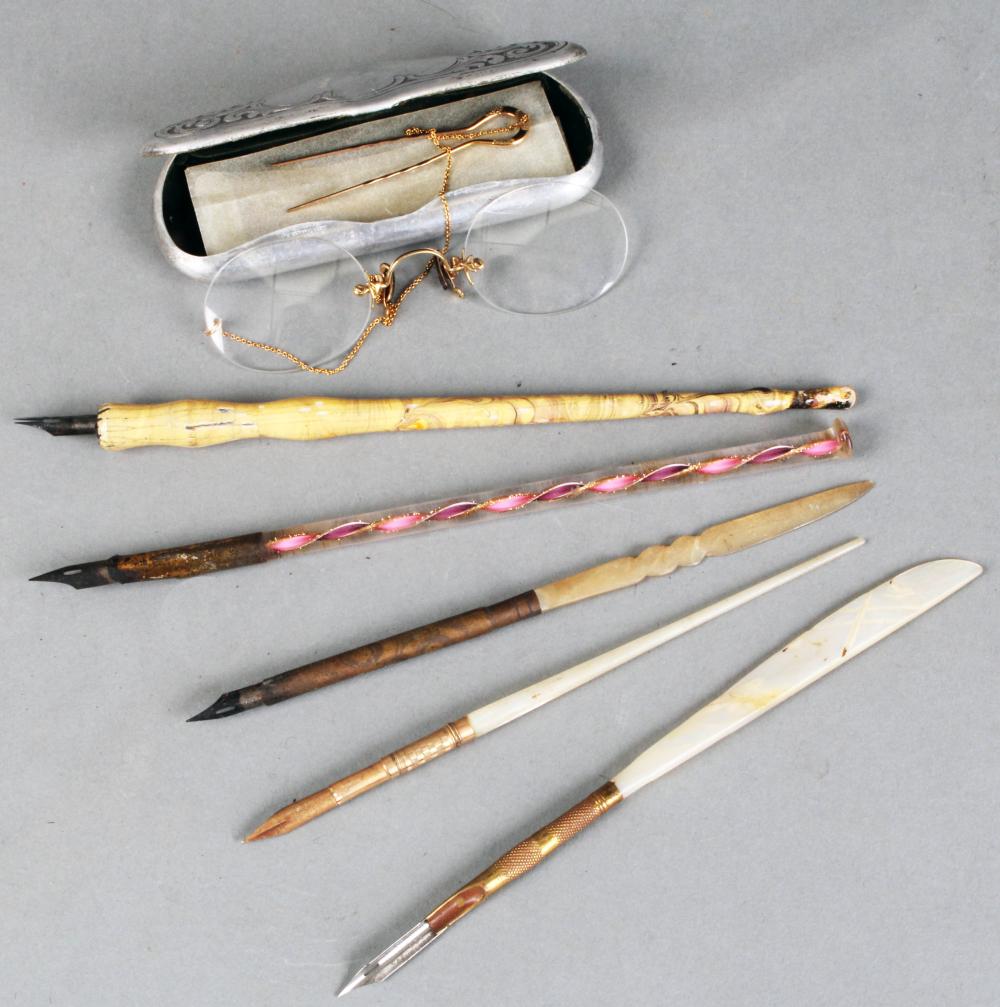 (6) Items: antique eyeglasses & ink pens: pair of armless glasses with chain & pin, along with an embossed hinged case; (5) Nilo pens in painted wood, Mother of Pearl and art glass stems (chip on glas sold by Roan Inc. Auctioneers & Appraisers, lot 218 — auction record photograph