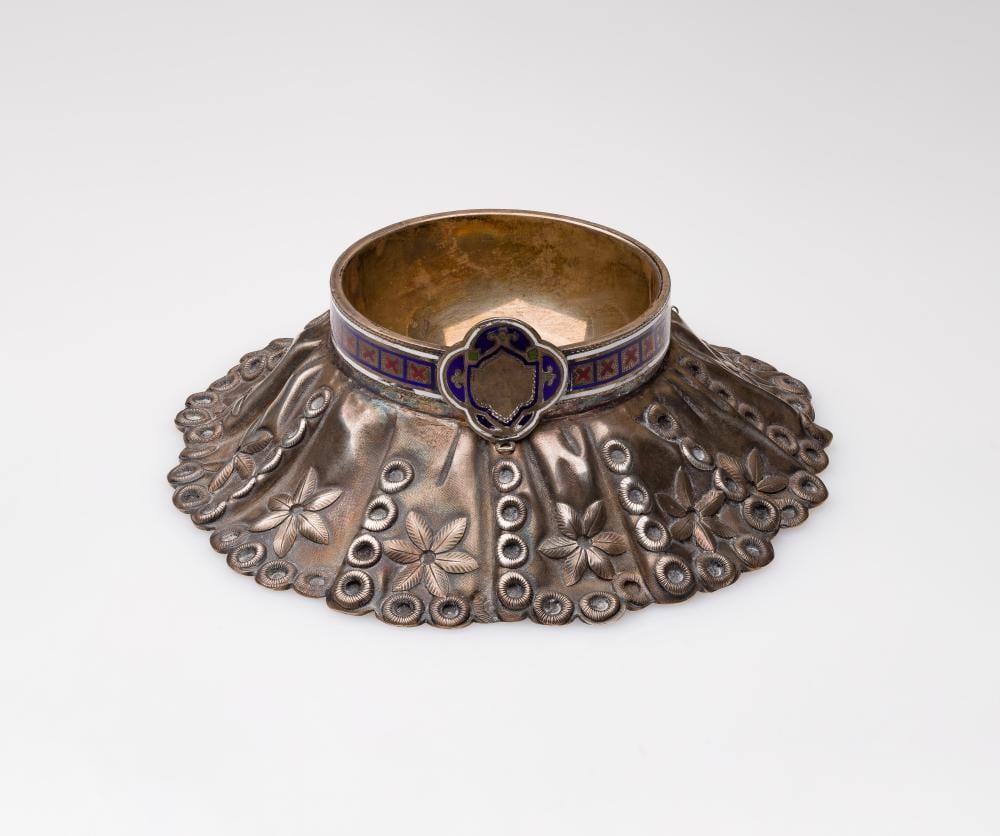 Silver-toned master salt cellar with ornate scalloped base and blue enamel band around the rim