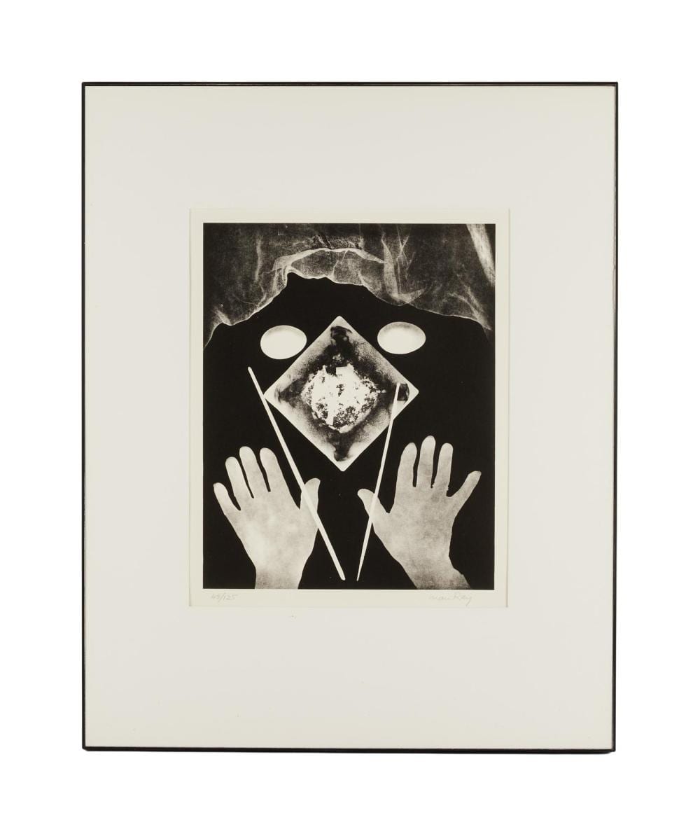 Framed black-and-white print of two open hands beneath a geometric face-like form and two white circles.