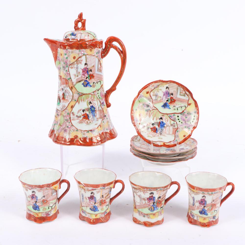 Red-handled Japanese-style porcelain tea set with hand-painted geisha scenes: teapot, four cups, and a decorative saucer plate.