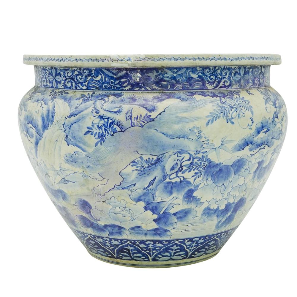 Blue-and-white porcelain fishbowl planter with floral and landscape motifs, shown front view.
