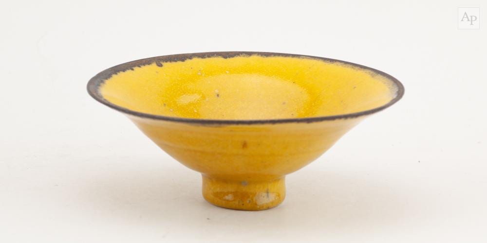 Emmanuel Cooper comparable auction result: emmanuel cooper 1938 2012 a porcelain bowl covered in uranium yellow glaze with manganese rim impressed mark diameter 18cm