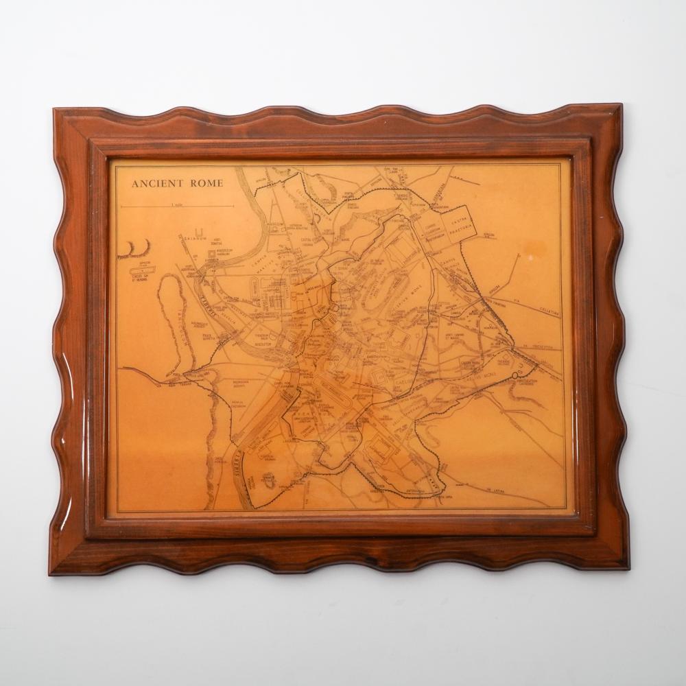Framed vintage-style map titled “ANCIENT ROME” showing streets and coastline, set under a clear resin-like cover.