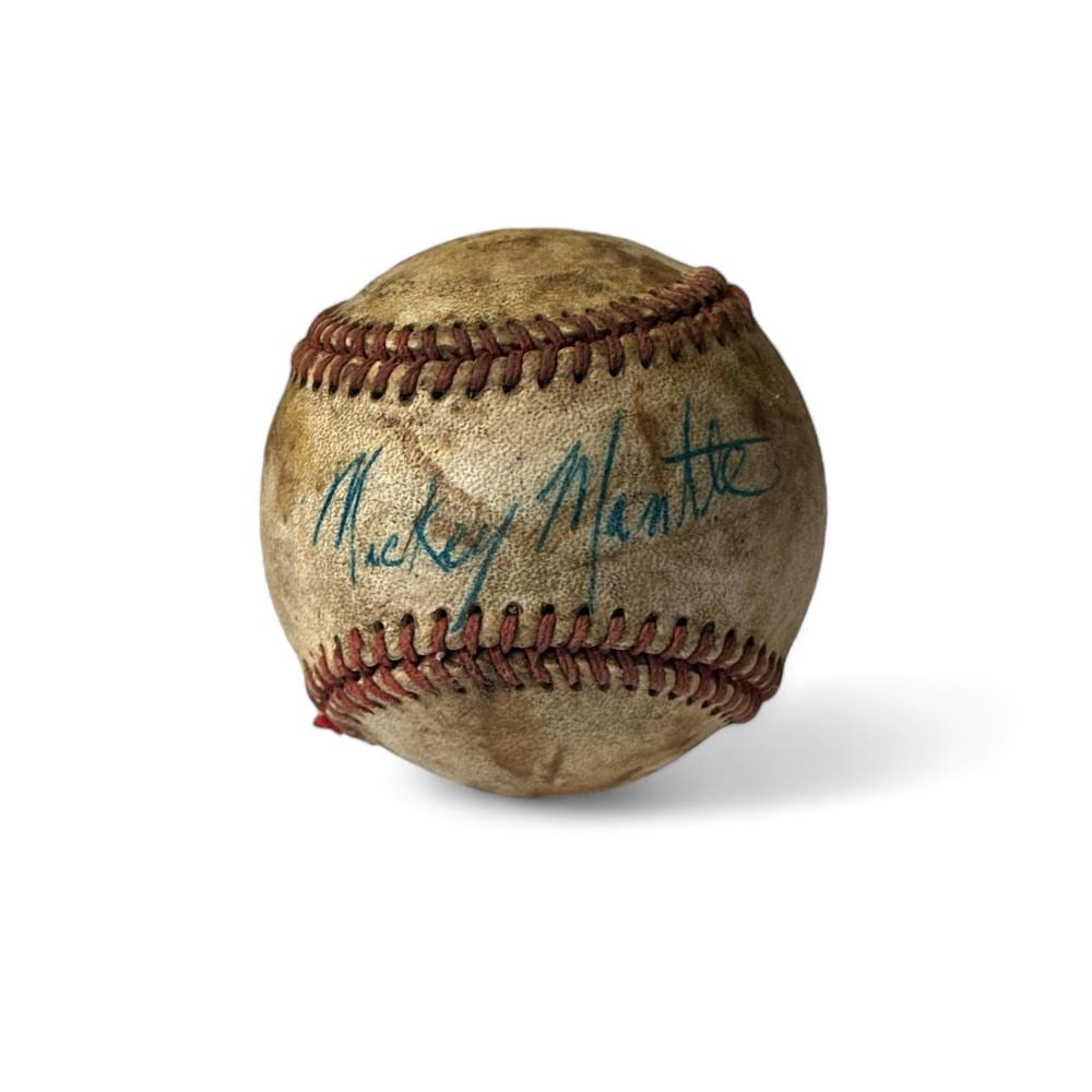 Signed baseball with blue autograph on a worn leather surface.