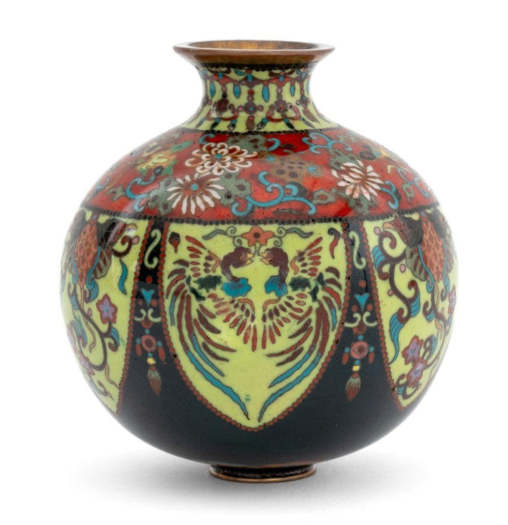 Colorful ovoid cloisonné enamel vase with blue, red, green, and gold floral and bird motifs on a light background.