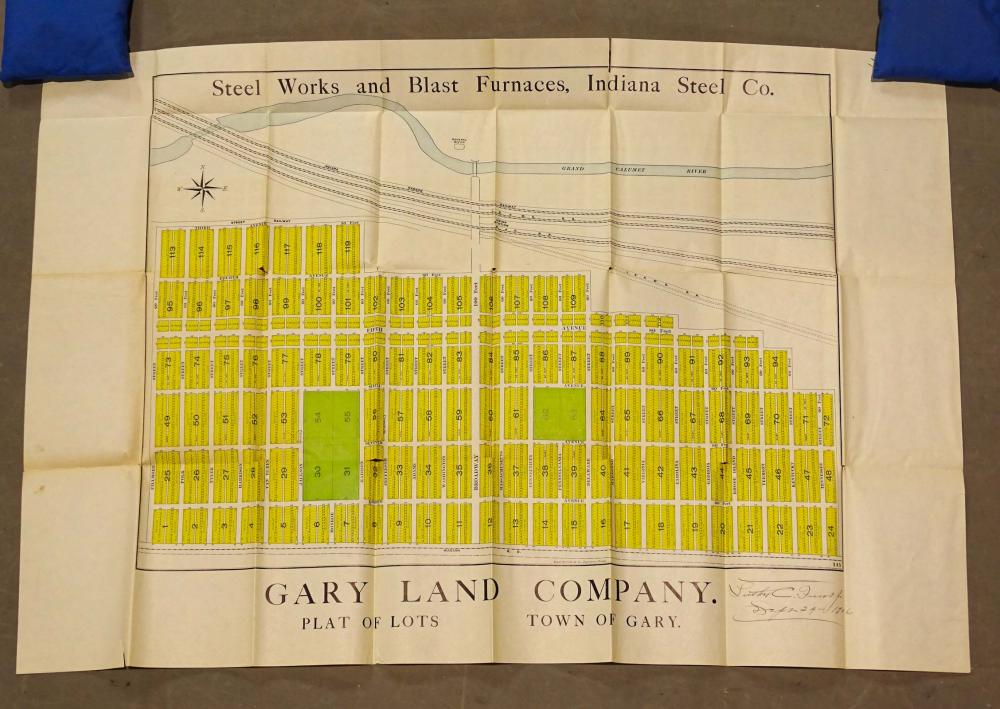 Open antique-style map showing an industrial layout with many numbered lots in yellow and black text, titled “Gary Land Company” and “Town of Gary.”