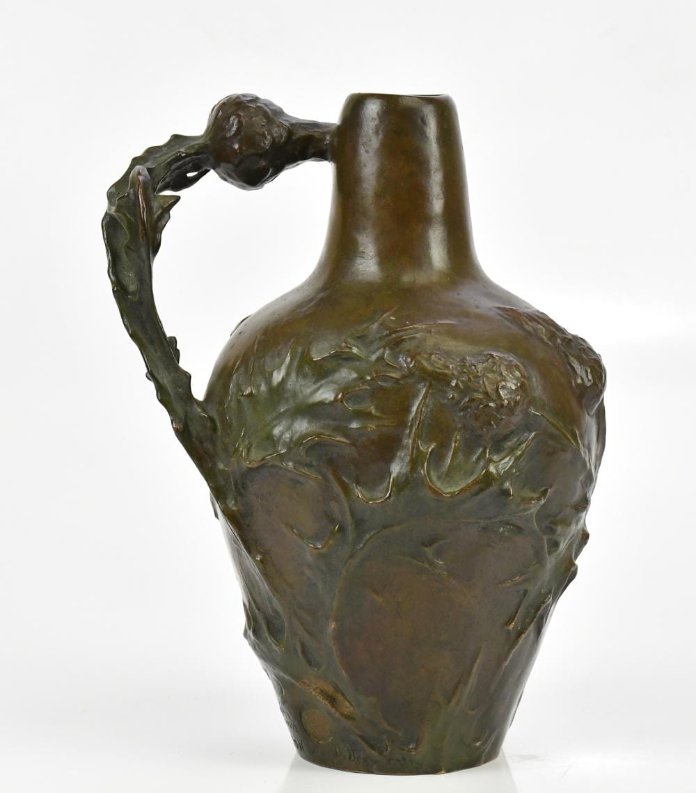 jeanne jozon 1868 1946 a art nouveau bronze flagon with a maiden s head and cast thistles and floral detail impressed stamp and foundry mark height 23cm · Adam Partridge Auctioneers · 2025-09-10 Jeanne Jozon comparable auction result: jeanne jozon 1868 1946 a art nouveau bronze flagon with a maiden s head and cast thistles and floral detail impressed stamp and foundry mark height 23cm
