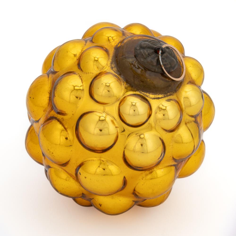 Amber glass Christmas ornament with a bumpy, bubble-like pattern and a black cap with a metal loop on top.