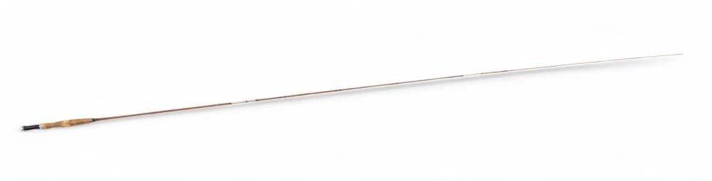 Long fishing rod shown horizontally on a white background, with a pointed tip and a wrapped handle area near one end.