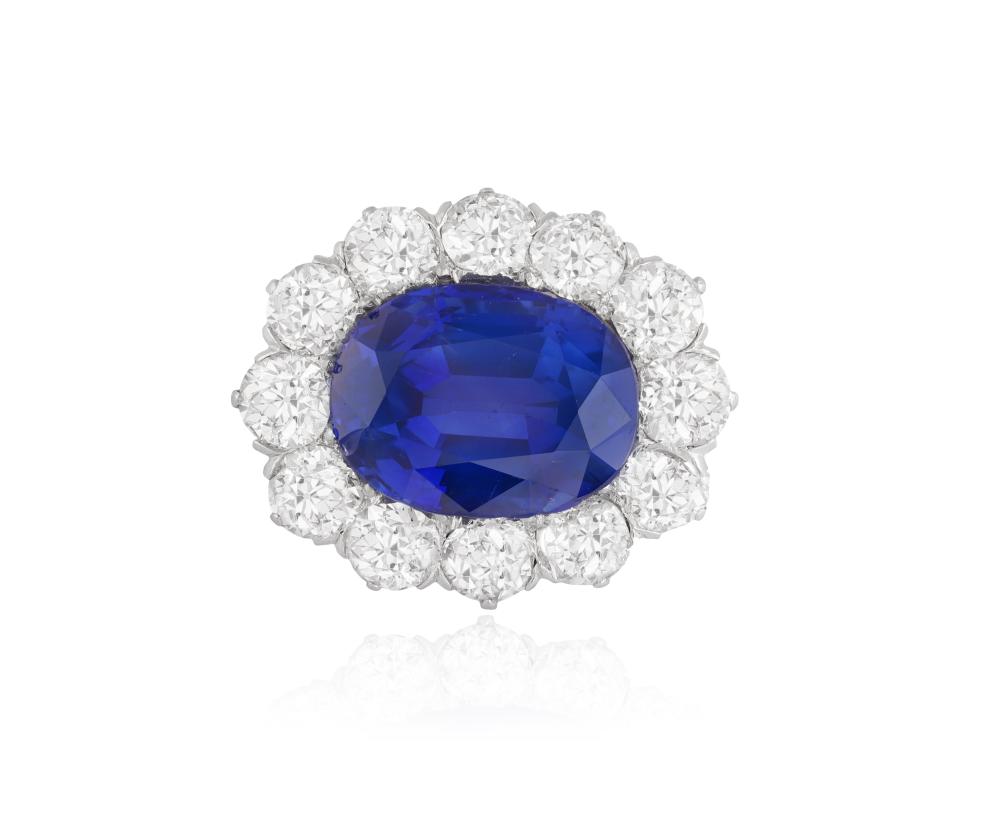 KASHMIR SAPPHIRE: A VERY RARE EARLY 20TH CENTURY SAPPHIRE AND DIAMOND BROOCH, CIRCA 1900 * No internet bidding for this lot Of cluster design, centring an oval-shaped sapphire weighing 8.24cts, within an frame of old-cut diamonds, diamonds app sold by Adam's, lot 47 — auction record photograph