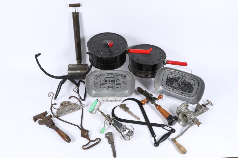 Lot of vintage utensils / tools: adjustable wrench, hand mixer egg beater, monkey wrenches, hand-cranked meat grinder, ice tongs, E-Z Corn Poppers, hand drill, Wilton Armetale pewter bread serving trays, candle holder, B sold by Ripley Auctions, lot 80 — auction record photograph