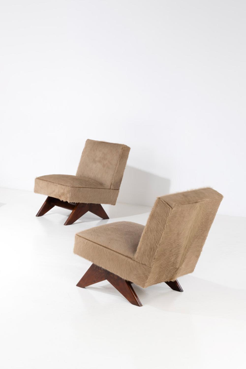 xx Pierre Jeanneret (1896-1967) Pair of 'Fireside' armchairs Teak and hide Painted inventory numbers 'P sold by Piasa, lot 199 — auction record photograph