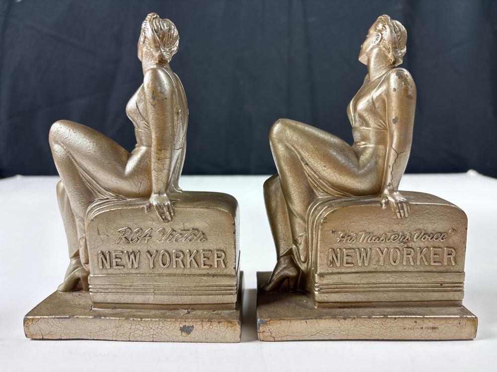 Unusual C. 1930'S Depression-Era Antique American Art Deco RCA “His Master's Voice” "New Yorker" Advertising Display, woman on radio, Metal paperweight/bookends, 7” High (each) sold by Ripley Auctions, lot 9639 — auction record photograph
