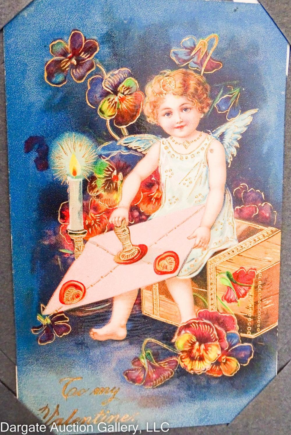 Blue postcard album cover showing a winged cherub holding a candle and surrounded by flowers and hearts.