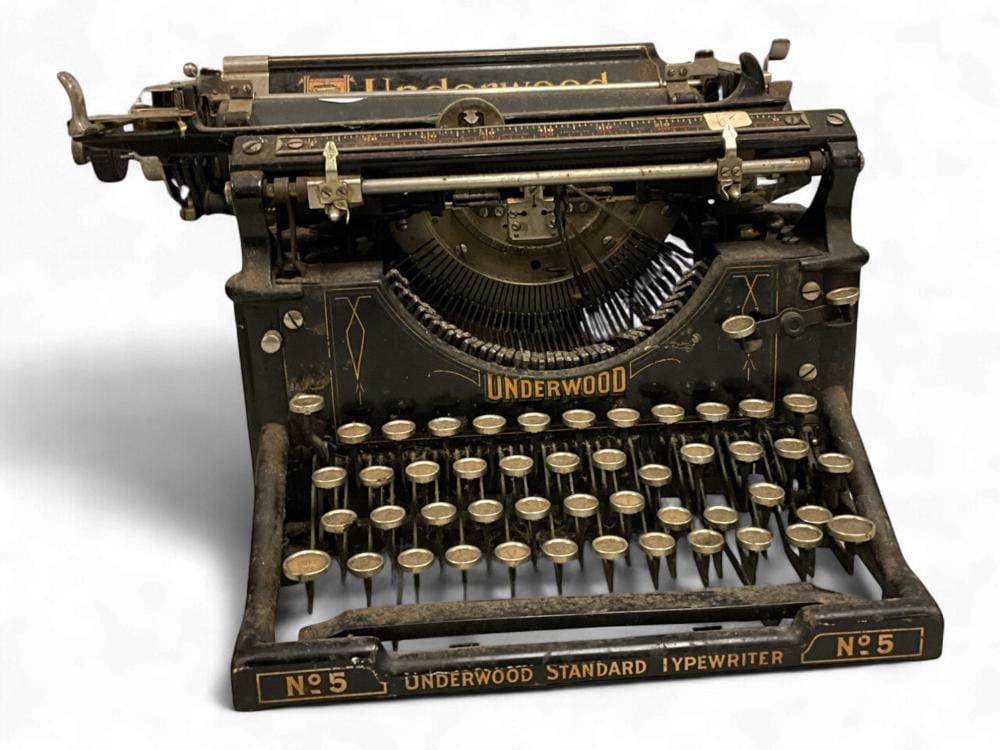 Antique black Underwood No. 5 standard typewriter with metal keys and raised paper guide.