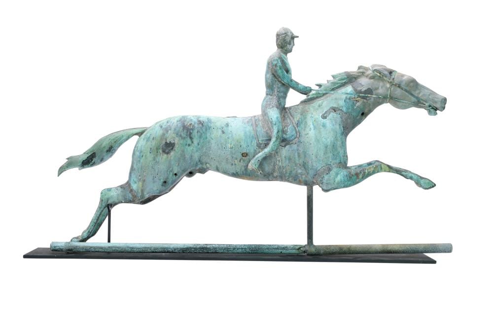 Green patina copper figure riding a rearing horse weather vane on a metal base, shown against a white background.