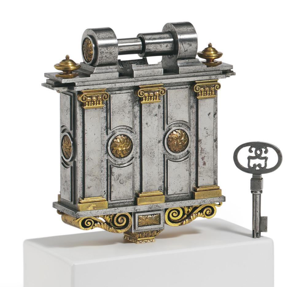 Decorative iron padlock with a key on a pedestal, featuring architectural columns and gold ornament on a gray metal body.