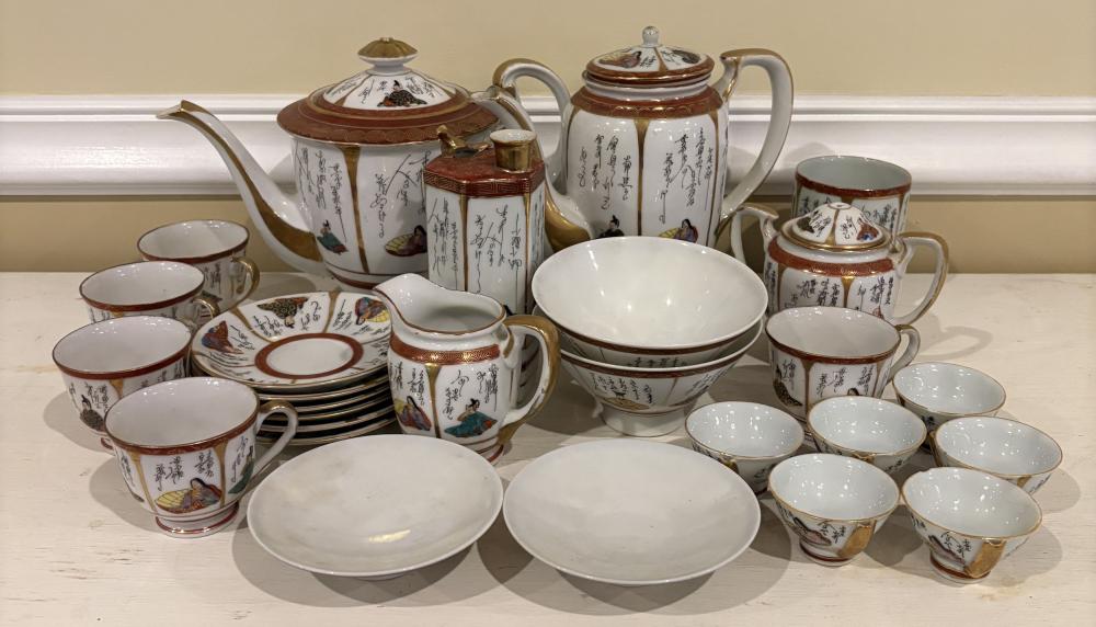 Vintage Japanese Kutani porcelain tea set with teapot, teacups, saucers, sugar bowl, and creamer decorated with colorful scenes and gold trim.