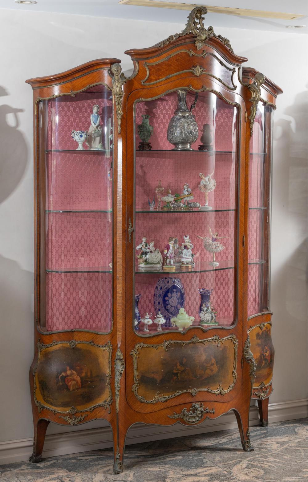 Auction comp thumbnail for An antique French display cabinet or vitrine in the rococo taste with gilt metal adornments, shaped glass front and shelves , the veneered based decorated with bucolic scenes Height 236cm x Width 150cm x Depth 45cm (Lawsons, Lot 50)
