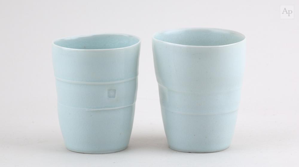 Edmund de Waal comparable auction result: edmund de waal born 1964 a near pair of porcelain beakers covered in pale celadon glaze impressed e marks glaze filled tallest 10cm 2