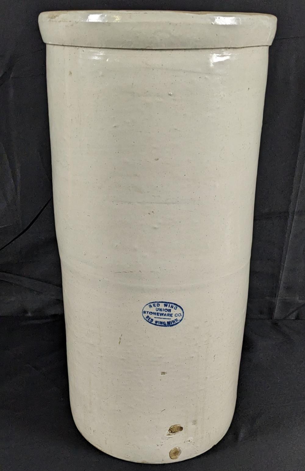Tall white stoneware crock with a blue stamp reading “Red Wing Union Stoneware Co.” and “Red Wing, Minn.”