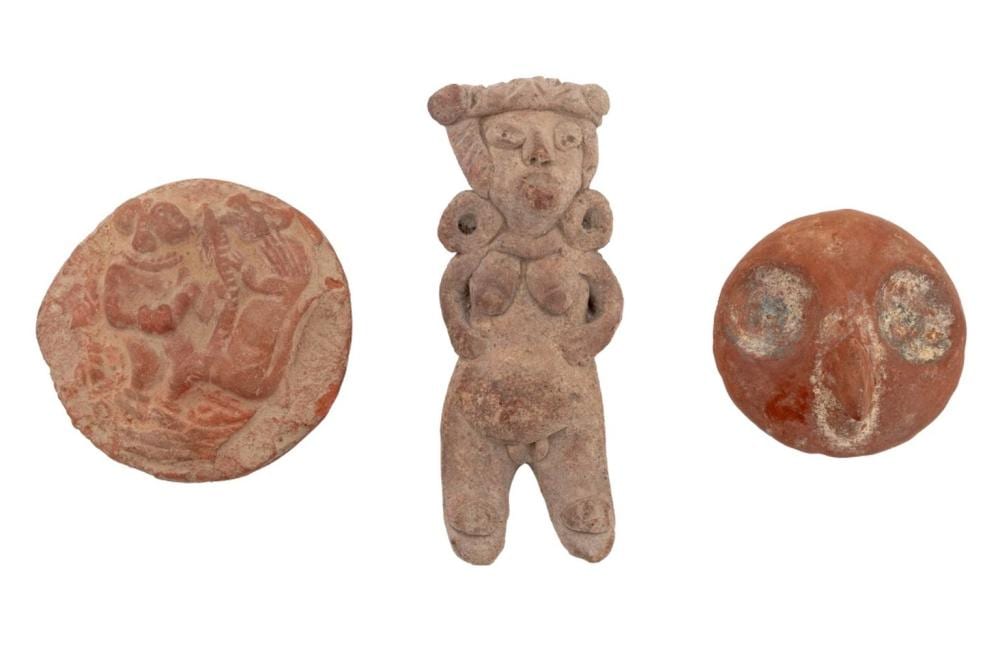 Three small terracotta Pre-Columbian-style pottery fragments shown on a white background: a human figure and two circular molded pieces with painted designs.