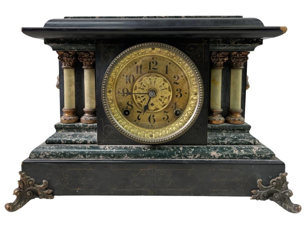 Front view of an ornate antique mantel clock with a round gold clock face and dark green marble base.
