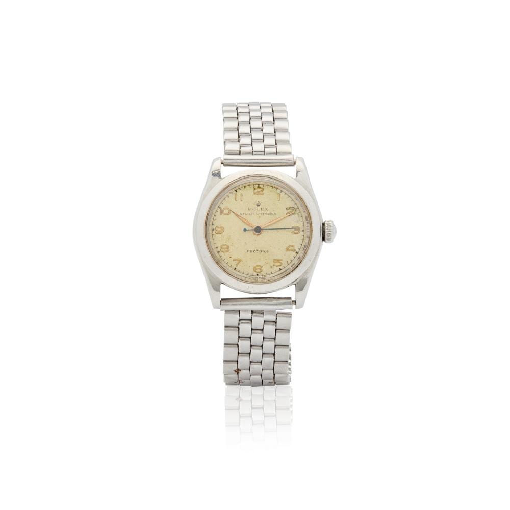 Front view of a stainless steel wristwatch with a round champagne dial and metal link bracelet, shown on a white background.